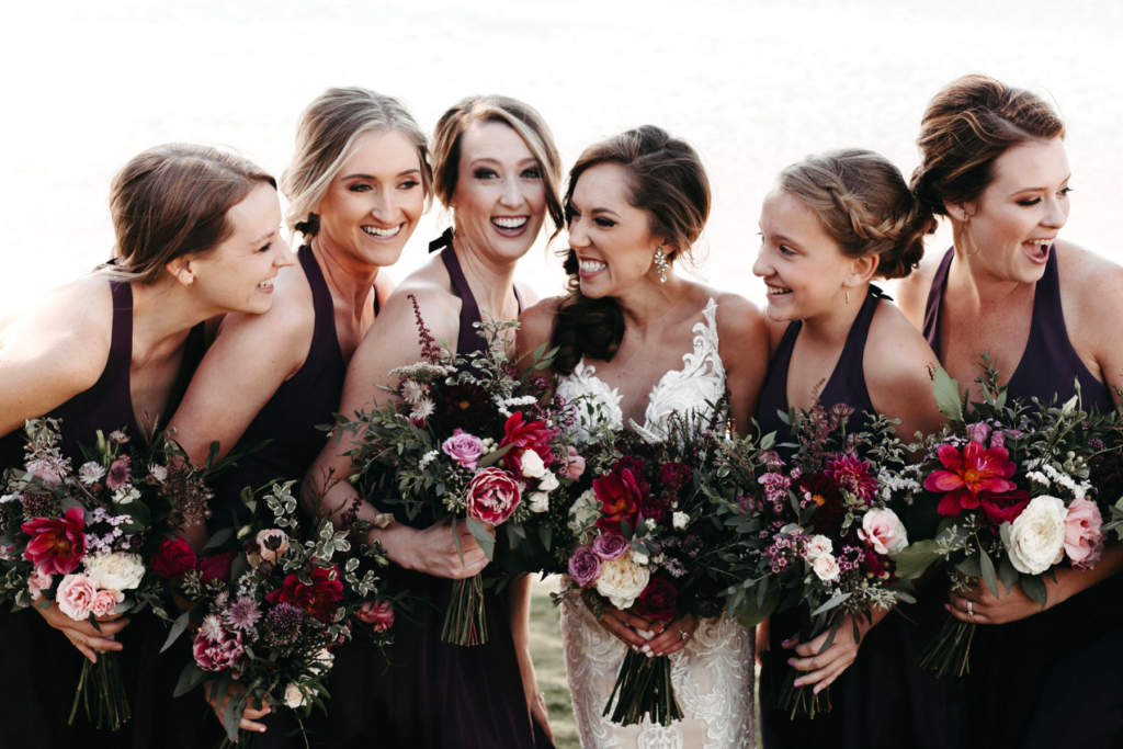 The Bride and Bridesmaids Laughing Together at a Fall Wedding in Lake Tahoe