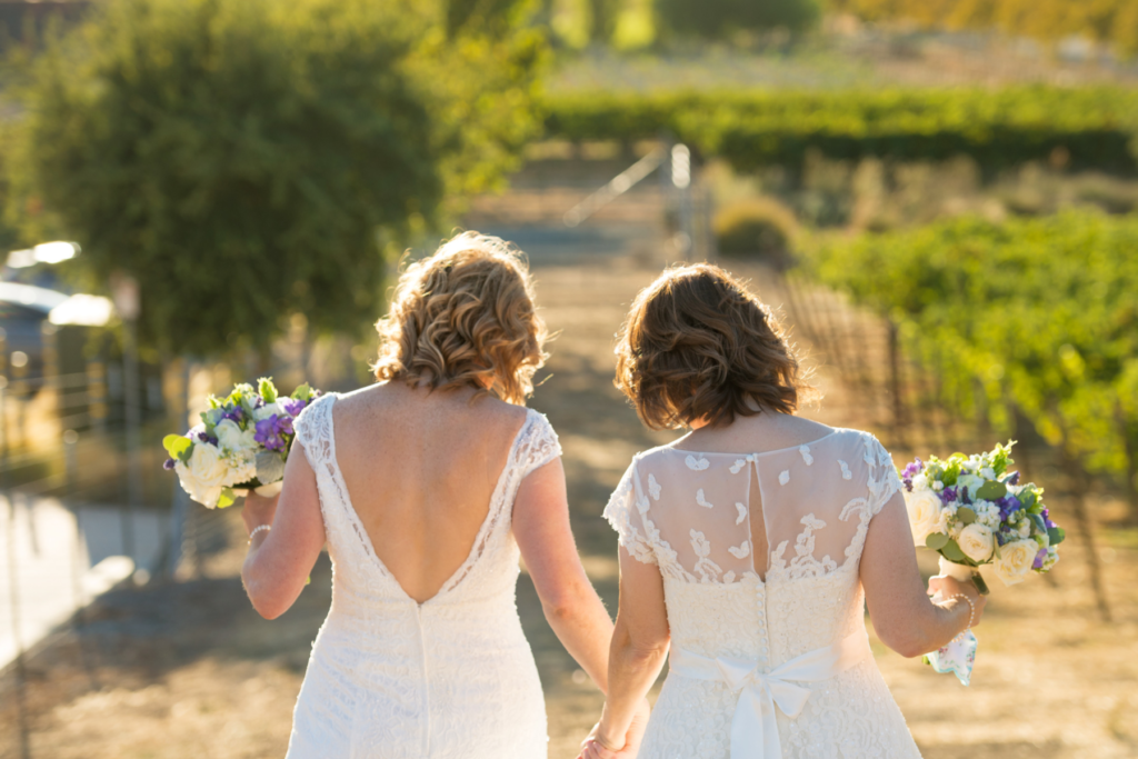 Two Women Holding Hands After Their Wedding Ceremony